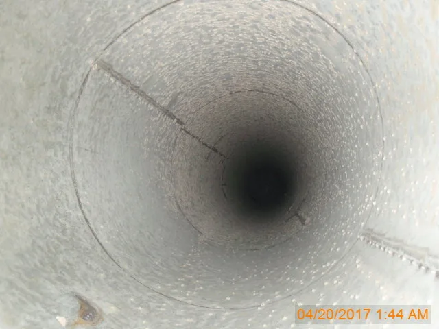 Looking down the inside of a cleaned round exhaust duct, from a CRC job photo