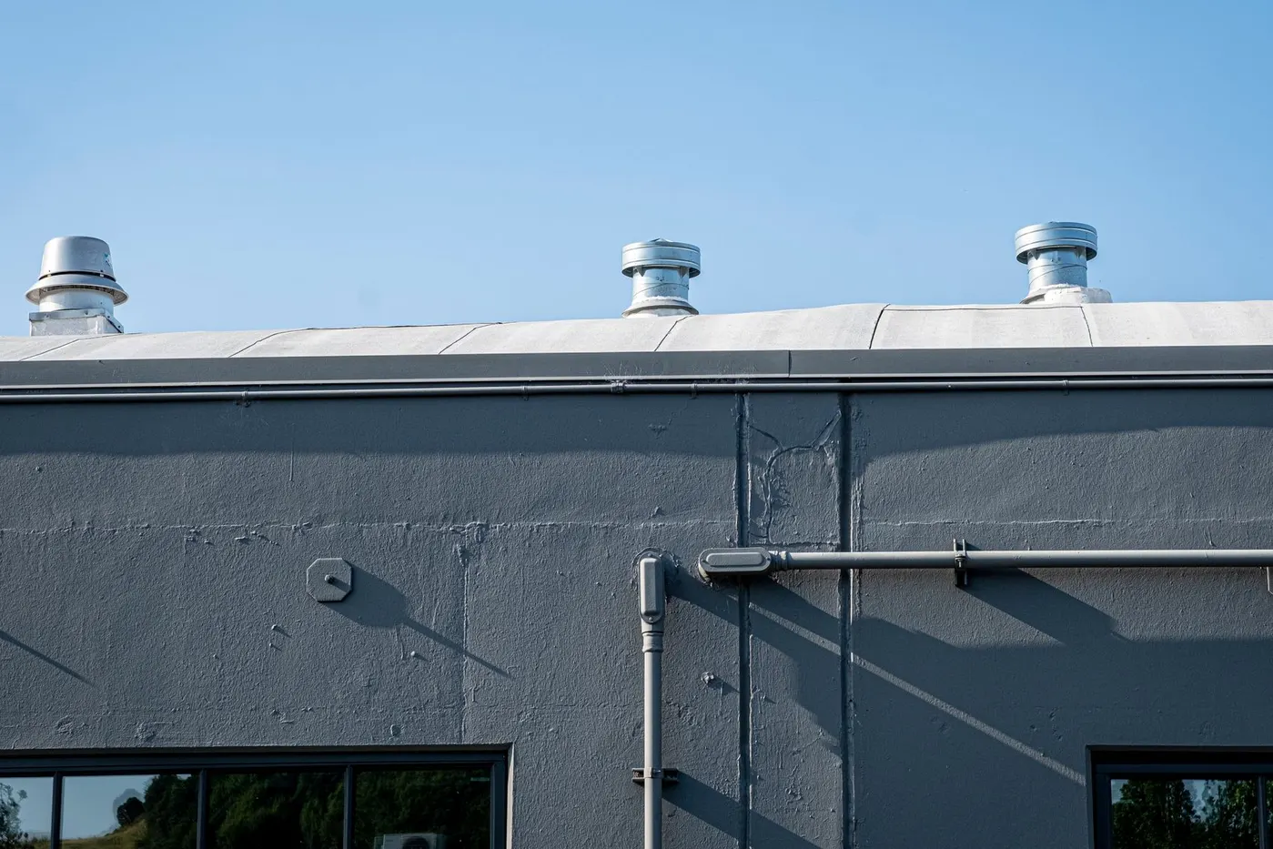 Stock photo of exhaust vents on the roof of a commercial building